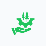 Hand holding gear with trees inside.