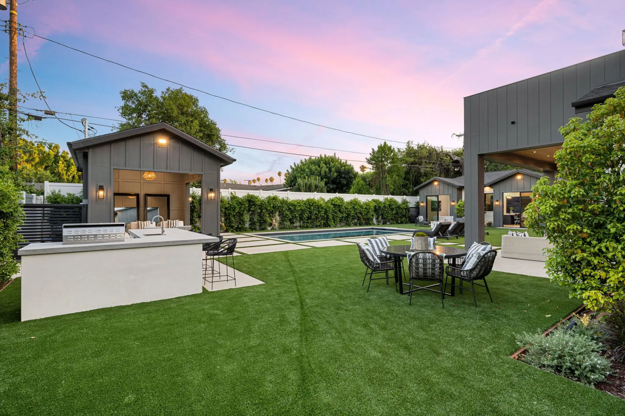 Modern backyard with pool and outdoor seating.